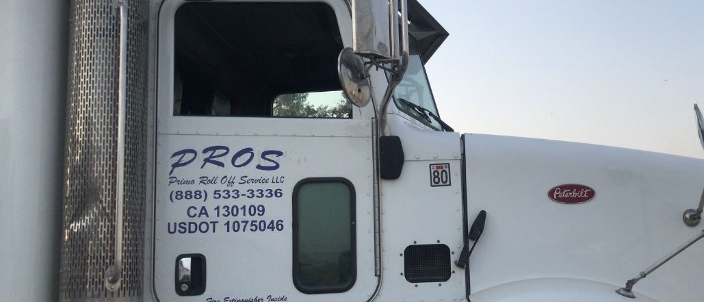 Peterbilt roll-off truck lettered PROS — Primo Roll Off Service LLC